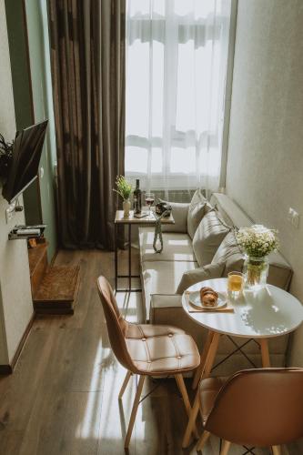 a living room with a couch and a table at Luxury Duplex Studios - City Center in Tbilisi City