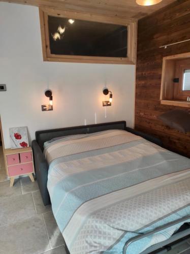 a bedroom with a bed and a tv on the wall at Studio Sainte Marie in Lanslebourg-Mont-Cenis