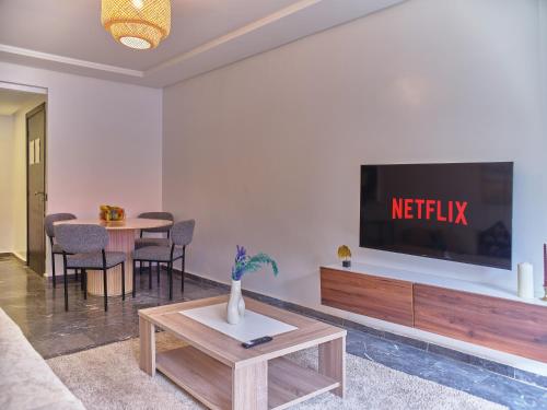 a living room with a television on a wall at TheCasaEdition Gauthier Residency City Center in Casablanca
