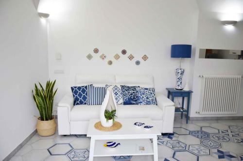 a living room with a white couch and a table at Mela & Cannella accommodation in Minori