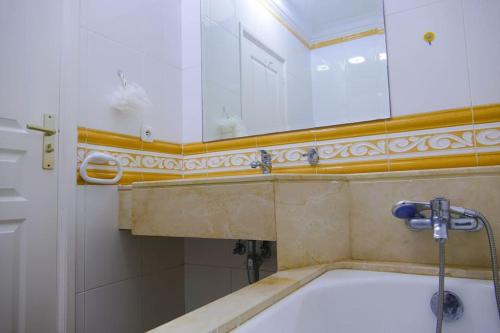a bath tub in a bathroom with a mirror at Villa luxueuse au centre du golf in Bouznika