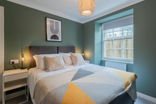 a bedroom with a large bed and a window at Priorsgate in St Andrews