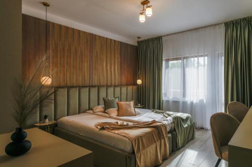 een slaapkamer met een bed, een raam en een tafel bij Residence Riverside in Galaţi