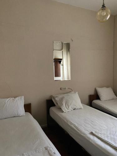a room with two beds and a mirror on the wall at otel ova in Konak