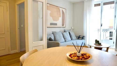 a living room with a table and a couch at Cervantes Prime in Valencia