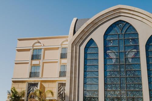 an image of a building with a large stained glass window at The Arkin Colony Hotel in Kérynia