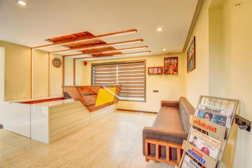a kitchen with a counter and a couch in a room at Hotel Deepali Executive in Aurangabad