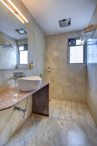 a bathroom with a sink on a counter at Hotel Deepali Executive in Aurangabad
