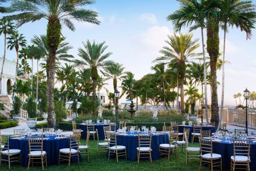 a wedding reception at the resort with blue tables and chairs at The Ritz-Carlton, Sarasota in Sarasota