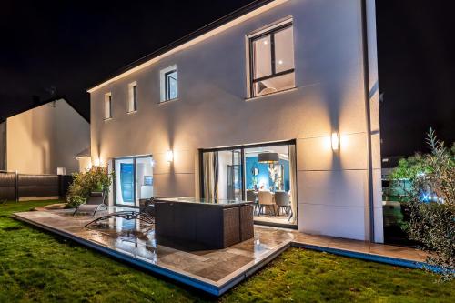 a house with a large window on the side of it at SUITE ET CHAMBRES COSY CHEZ A&M -ELEGANT HOME, CALME, CAMPAGNE, PARKING gratuit in Épône
