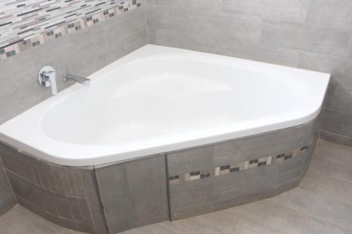 a bathroom with a white sink in a shower at Malabi Exclusive Lodges in Lilongwe
