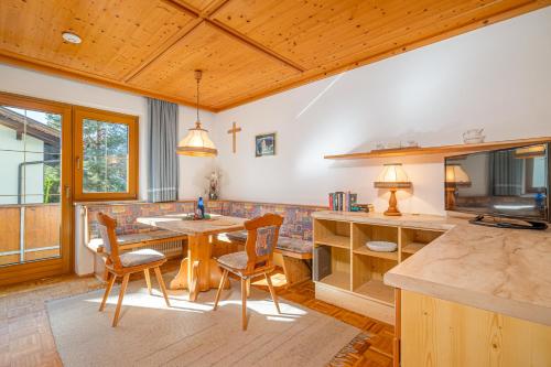 a kitchen with a table and chairs in a room at Appartements Spitzegel in Hermagor