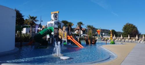 a playground in a park with a water slide at LJ Cosy Lodge - Mobilhome in Houlgate