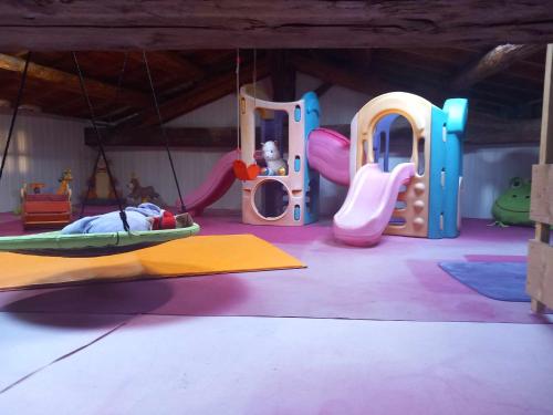 a childrens play room with a playground with a slide at Vintage ,le paradis des enfants wifi draps parking free in Thiers