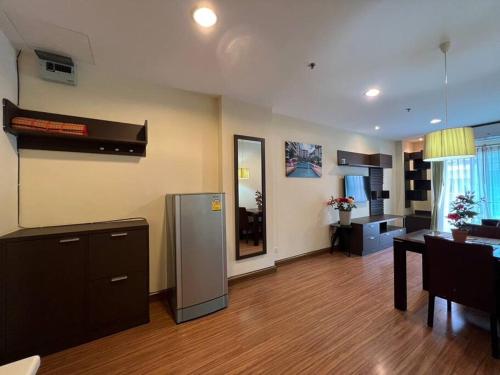 a living room with a kitchen and a dining room at Quiet Patong Apartment near Night Life & Good Food in Patong Beach