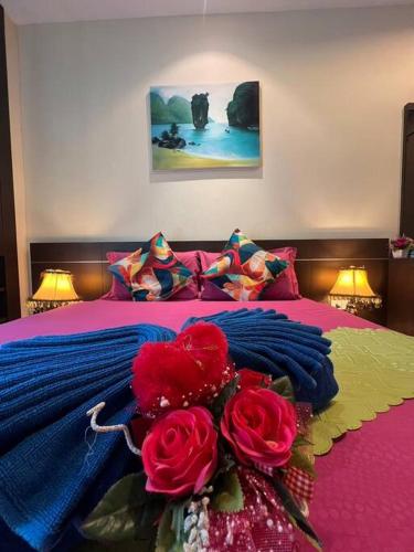 a bedroom with a bed with flowers on it at Quiet Patong Apartment near Night Life & Good Food in Patong Beach