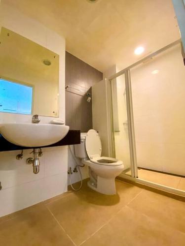 a bathroom with a toilet and a sink and a shower at Quiet Patong Apartment near Night Life & Good Food in Patong Beach
