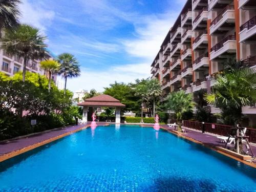 a swimming pool in front of a building at Quiet Patong Apartment near Night Life & Good Food in Patong Beach