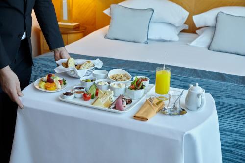 a tray of food on a table in a hotel room at Wyndham Grand Izmir Ozdilek Thermal & Spa in Izmir