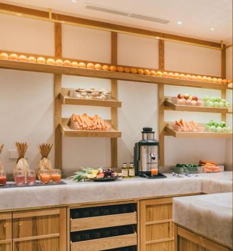 a kitchen with a counter with plates of food at Posthotel Achenkirch Resort and Spa - Adults Only in Achenkirch