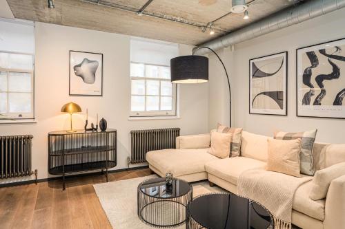 a living room with a couch and a table at Be London - The Southwark Residences in London