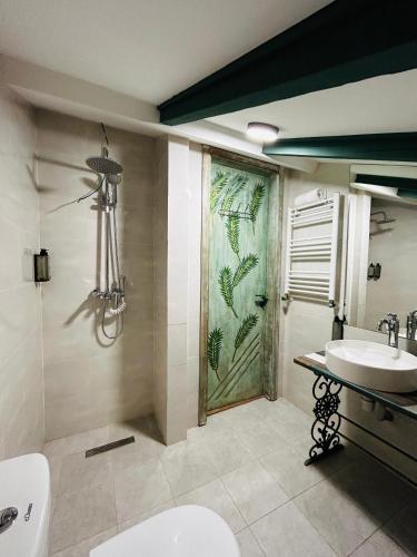 a bathroom with a toilet and a sink and a window at Hotel Zerta Old Tbilisi in Tbilisi City