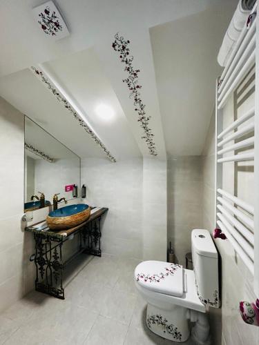 a bathroom with a toilet and a sink at Hotel Zerta Old Tbilisi in Tbilisi City