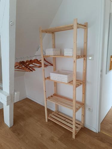 a wooden ladder shelf in a room with a closet at Gîte chez Julie et Franck in Cappy