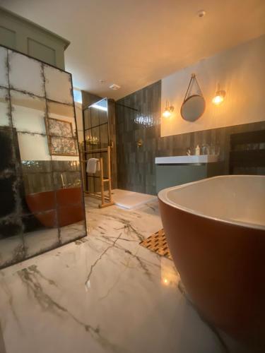 a bathroom with a bath tub and a sink at Halford House - Adults Only in Bourton on the Water