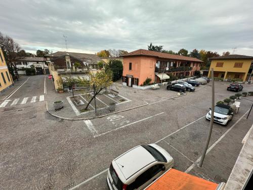 a parking lot with cars parked in front of a building at Basiglio Centro Storico in Basiglio