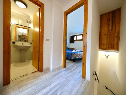 a bathroom with a sink and a mirror at Hostdomus - Sansicario R19 in Cesana Torinese