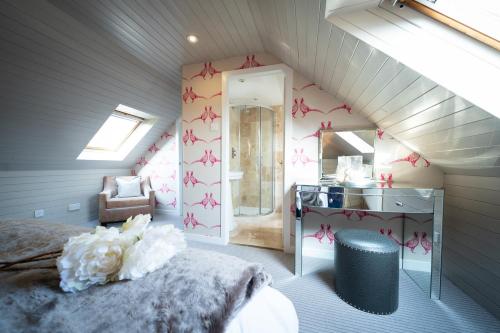 a bedroom with a bed and a desk and a mirror at Nether Glenny Farm in Stirling