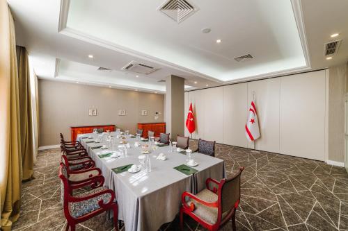 a conference room with a long table and chairs at The Arkin Colony Hotel in Kérynia