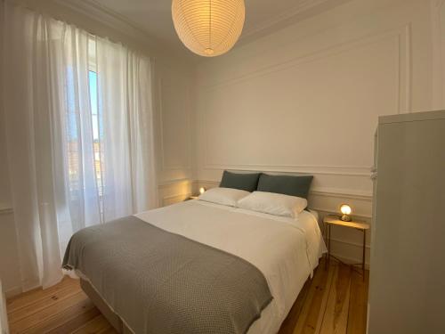a bedroom with a bed and a large window at Sintra Clássica in Sintra