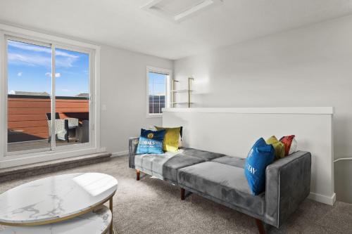a living room with a couch and a table at GlobalStay Cranbrook Townhome Suites in Calgary
