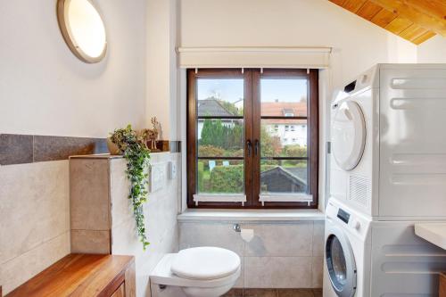 a bathroom with a toilet and a window at Bergchalet 20 in Diemelsee