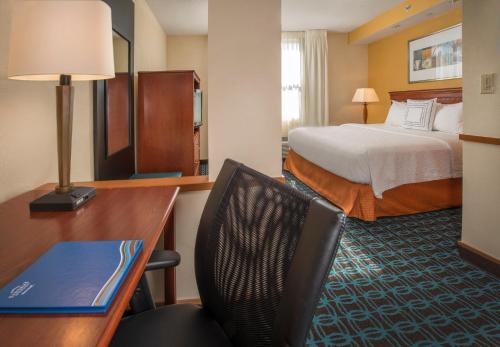 Fairfield Inn & Suites by Marriott Williamsburg في وليامزبورغ: غرفة الفندق بسرير ومكتب وكرسي