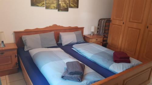 a bedroom with two beds with blue and white sheets at FeWo H.Reußwig in Arrach