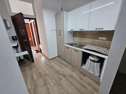 a small kitchen with a sink and a counter at B&B DEI SOGNI in centro, con facilità di parcheggio in Cosenza