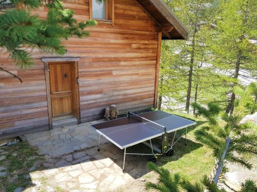 a ping pong table in front of a cabin at Slope-Side Chalet w/Jacuzzi, Home Cinema, for 16 Guests in Montgenèvre