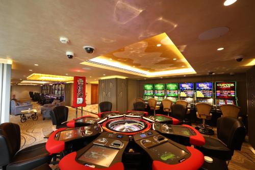 a casino with a bunch of video poker machines at The Arkin Colony Hotel in Kérynia