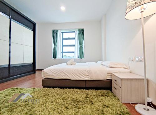 a bedroom with a bed and a large window at Sun Sky by Evernent in Miri
