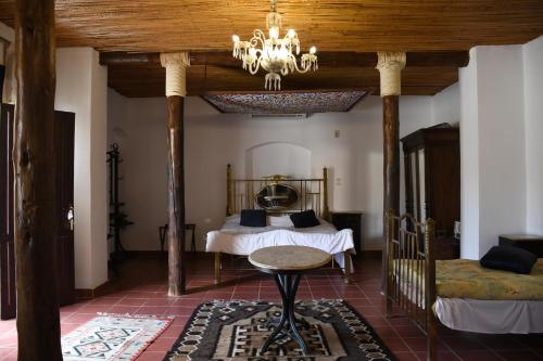 a bedroom with a bed and a chandelier at Tzila Bahariya in Az Zaytūn