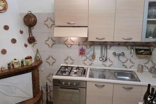 a kitchen with a stove and a sink at Casa San Francesco in Agnone