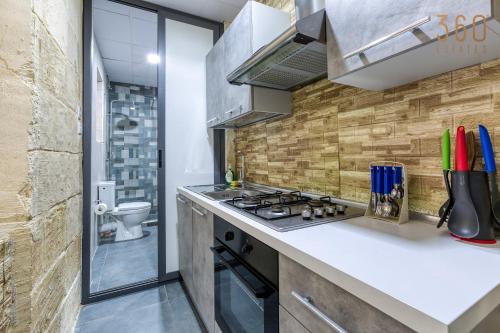 Charming 1BR home in the heart of Isla by 360 Estates 주방 또는 간이 주방