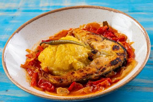 a bowl of food with fish and mashed potatoes at Residence Riverside in Galaţi