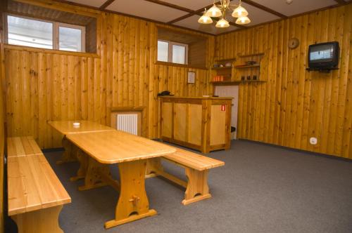 a room with a wooden bench and a tv in it at Rahat Hotel in Aktau