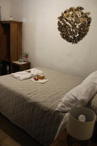 a bedroom with a bed with a wreath on the wall at POUSADA SERTÃO DA BOCAINA in Cunha