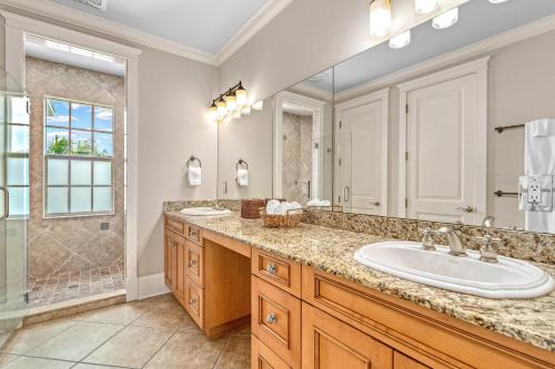 a bathroom with two sinks and a large mirror at The Key Canal - 455 in Siesta Key