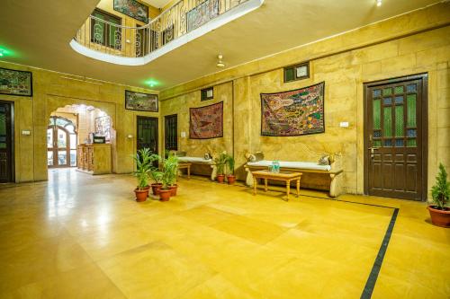 a large room with potted plants on the walls at Hotel Marina Mahal with Swimming Pool in Jaisalmer